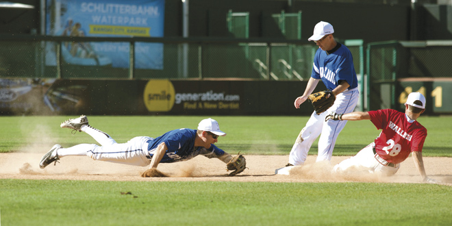 Benedictine Father Paul Sheller dives for second base to tag out Father Scott Wallisch as Father Kevin Drew stands over second. (photos courtesy of The Leaven)