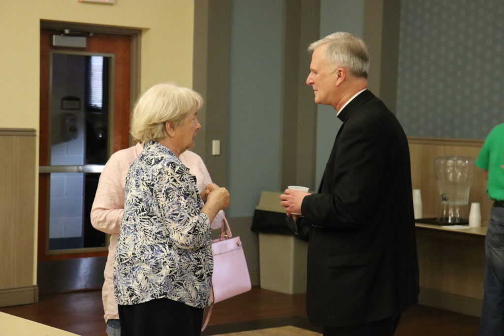Bishop Johnston stayed after the presentation to speak with parishioners following the meeting.