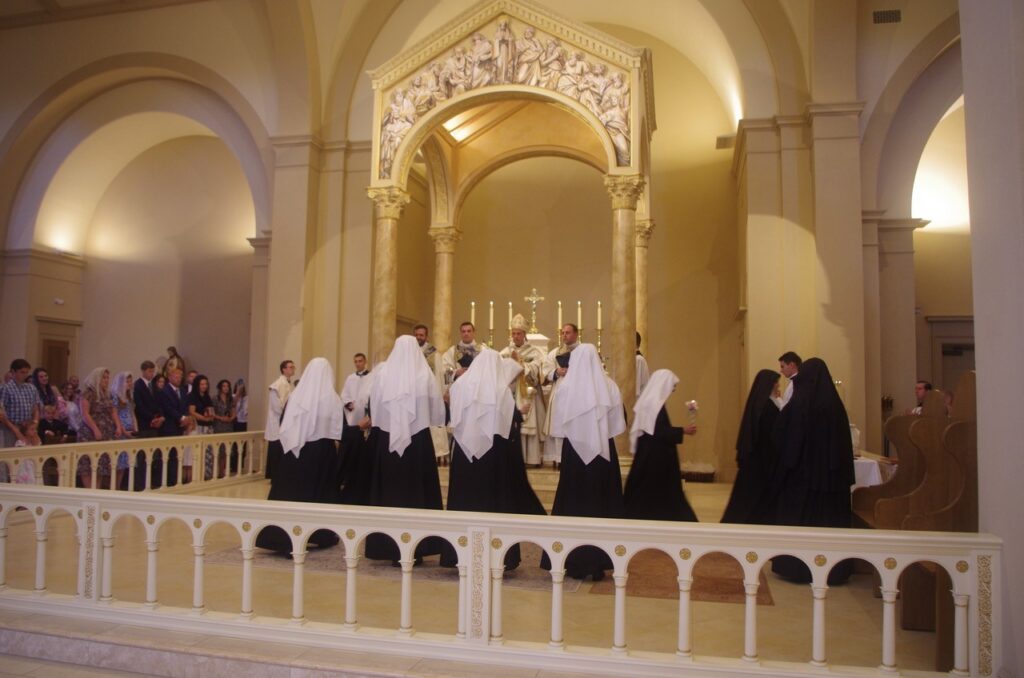 Sister Photina stands with the other novices before the altar at the Benedictines of Mary, Queen of Apostles Abbey on the day their investiture.